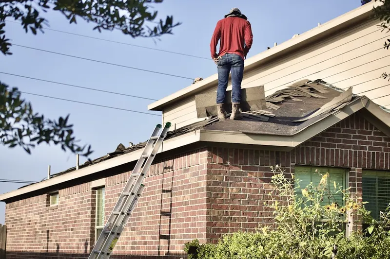 Professional roofer working on a residential roof in West Hamburg